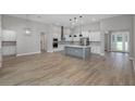 Open-concept home with hardwood floors flows from the kitchen to living room at 13704 Oldenburg Dr, Hudson, FL 34667