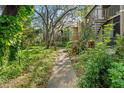 Charming exterior view of home with lush greenery, walkway, and inviting entrance at 14211 Shadow Moss Ln # 101, Tampa, FL 33613