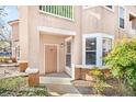 Close-up view of a condo front door with a covered porch and well-maintained landscaping at 17978 Villa Creek Dr, Tampa, FL 33647