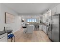 Bright, open-concept kitchen featuring modern stainless steel appliances, a breakfast bar, and hardwood floors at 226 5Th N Ave # 901, St Petersburg, FL 33701