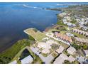 Panoramic aerial view showcasing the neighborhood, nearby waterways, and lush greenery at 25 Windrush Bay Dr # 25, Tarpon Springs, FL 34689