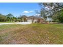 Home features a well-manicured lawn and three car garage at 27930 Ravens Brook Rd, Wesley Chapel, FL 33544