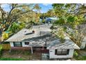 An aerial view of the property showing a well maintained roof with mature trees surrounding the property at 3112 S Julia Cir, Tampa, FL 33629