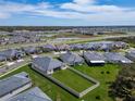 New home community aerial view showing a community with sidewalks, and community ponds at 31999 Surfton Knot Ct, San Antonio, FL 33576