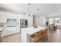 Bright kitchen features a large island with seating, stainless steel appliances, and modern finishes at 3579 Sweet Mabolo St, Wesley Chapel, FL 33543