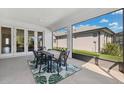 Covered patio with outdoor dining set, offering a perfect space for relaxation and entertaining at 3579 Sweet Mabolo St, Wesley Chapel, FL 33543