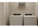 Functional laundry room equipped with modern washer and dryer at 36027 Joseph Blake St, Zephyrhills, FL 33541