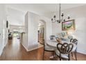 Inviting dining room with chandelier and a view into the kitchen and living area, creating an open and airy feel at 3638 Trafalgar Way # 103, Palm Harbor, FL 34685