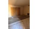 Living room needing repair, showcasing tile flooring and boarded closet space at 4215 E Bay Dr # 1701B, Clearwater, FL 33764