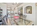 Bright dining room with a glass table, ornate metal chairs, and views into the home's open floorplan at 4410 Sawgrass Dr, Palm Harbor, FL 34685