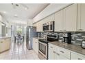 Well-lit kitchen boasting stainless steel appliances, tiled backsplash, and plenty of cabinet space at 4410 Sawgrass Dr, Palm Harbor, FL 34685