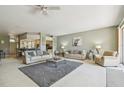 Spacious living room with neutral tones, ceiling fan, and comfortable seating arrangement at 4410 Sawgrass Dr, Palm Harbor, FL 34685