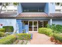 Building entrance featuring address number 5279, a blue tiled fountain, and lush landscaping at 5279 Isla Key S Blvd # 313, St Petersburg, FL 33715