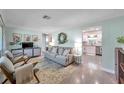 Inviting living room featuring neutral paint, modern furniture, and seamless flow into the kitchen at 536 63Rd S Ave, St Petersburg, FL 33705