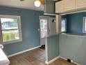 Kitchen with tile flooring, white cabinets, neutral colored countertops, and an open layout to the living spaces at 624 Folsom S St, St Petersburg, FL 33707
