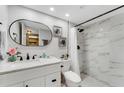 Updated bathroom with a marble shower, modern vanity, and oval mirror at 7623 Radcliffe Cir # A101, Port Richey, FL 34668