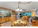 Bright living area with a bar, dining area, and sliding glass doors to the lanai at 7623 Radcliffe Cir # A101, Port Richey, FL 34668