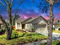 Well-kept single-Gathering home with a neat lawn and a two-car garage framed by large trees at 7853 Bristol Park Dr, Apollo Beach, FL 33572