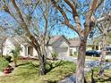 Beautiful home featuring mature trees, a well-manicured lawn, and inviting curb appeal at 7853 Bristol Park Dr, Apollo Beach, FL 33572