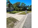 Well-maintained front yard with a long driveway leading to a single-story home at 8588 95Th Ave, Seminole, FL 33777