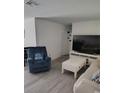 Bright living room featuring modern flooring, comfortable seating, and a large television at 8588 95Th Ave, Seminole, FL 33777