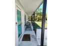 Cozy porch with seating and a welcoming entrance to the home at 8588 95Th Ave, Seminole, FL 33777
