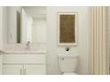 Bright bathroom featuring modern white vanity, toilet, beige accent wall decor and a luxurious shower curtain at 10630 Gable Dig Loop, San Antonio, FL 33576