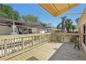 Newly built deck with wooden rails and awning, perfect for outdoor entertaining and relaxation at 12519 Cambridge Ave, Tampa, FL 33624