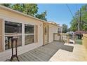 A view of the home's exterior, highlighting the large deck and front entrance at 12519 Cambridge Ave, Tampa, FL 33624