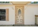 A close-up of the home's front door and shuttered window at 12519 Cambridge Ave, Tampa, FL 33624
