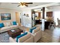 Bright living room featuring wood flooring, stainless steel kitchen appliances and a large comfortable seating area at 1509 Lemon St, Clearwater, FL 33756