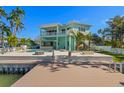 Gorgeous waterfront backyard with a luxurious pool, spa, dock, and outdoor entertaining space at 15904 Redington Dr, Redington Beach, FL 33708