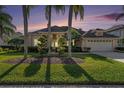 Charming home with a well-manicured lawn and meticulous landscaping at 18823 Wimbledon Cir, Lutz, FL 33558
