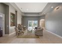 Spacious living room with fireplace, tray ceiling, and sliding glass doors to the lanai at 18823 Wimbledon Cir, Lutz, FL 33558