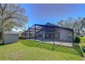 Expansive backyard with screened pool and shed offering outdoor living and storage at 3115 Bent Creek Dr, Valrico, FL 33596