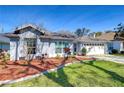 Well-maintained home exterior featuring manicured landscaping and a spacious two-car garage at 3115 Bent Creek Dr, Valrico, FL 33596