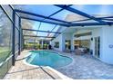 Stunning screened-in pool area features a sparkling pool and comfortable outdoor seating at 3115 Bent Creek Dr, Valrico, FL 33596