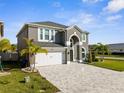 Beautiful two-story home featuring a lush lawn, paver driveway, and an attached two-car garage at 3654 Beneraid St, Land O Lakes, FL 34638