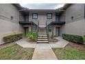 Exterior view of the building with stairs and a small garden at 4112 Ashford Green Pl # I203, Tampa, FL 33613