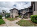 Exterior of building featuring stairs to upper level and garden area at 4112 Ashford Green Pl # I203, Tampa, FL 33613