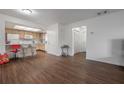 Open floor plan with modern laminate flooring, connecting living and kitchen areas at 4112 Ashford Green Pl # I203, Tampa, FL 33613