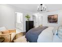 Bright bedroom with dark hardwood floors, neutral decor, and ensuite bathroom at 4511 S Manhattan Ave # 32, Tampa, FL 33611