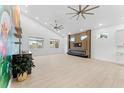 Spacious living room featuring light wood floors, a decorative accent wall, and large windows at 4907 15Th N Ave, St Petersburg, FL 33710