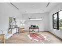 Bright and airy office space with light hardwood flooring, modern furnishings, and a large window offering a view at 5017 W Dickens Ave, Tampa, FL 33629