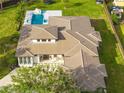 Expansive house with a manicured lawn, in-ground pool with waterslide, and a sprawling tile roof at 5546 Drexel Rd, Land O Lakes, FL 34638