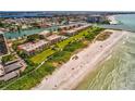 A scenic aerial view of condos by the beach, complete with lush landscaping and recreational facilities at 7564 Bayshore Dr # 207, Treasure Island, FL 33706
