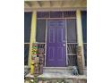 Inviting front door with unique tiki statues, and a decorative sunburst trim above the door at 1044 Virginia Dr, Sarasota, FL 34234