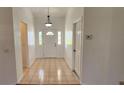 Bright entryway with neutral tile flooring and a traditional front door featuring a half-round window at 11722 Currie Ln # E1, Largo, FL 33774