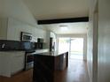 Bright kitchen featuring a large island, stainless steel appliances, black backsplash, and white cabinets at 16147 Sagebrush Rd, Tampa, FL 33618