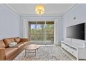 Bright living room featuring a sliding door to the balcony, modern furnishings, and light-colored tile flooring at 17106 Carrington Park Dr # 622, Tampa, FL 33647